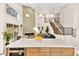 Modern kitchen island with quartz countertops and light wood cabinets at 5201 Rim View Ln, Las Vegas, NV 89130