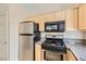 Kitchen features stainless steel appliances and wood cabinets at 5250 S Rainbow Blvd # 2056, Las Vegas, NV 89118