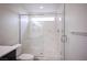 Modern bathroom features a glass enclosed shower with marble tiling and a window at 5391 Kennedy Hill Ave, Las Vegas, NV 89139