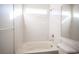 Bathroom with shower-tub combo, white marbled surround, and brushed nickel fixtures at 5391 Kennedy Hill Ave, Las Vegas, NV 89139