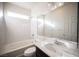 Clean bathroom with a bathtub, vanity, and marble-look walls at 5391 Kennedy Hill Ave, Las Vegas, NV 89139