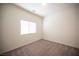 Bedroom featuring a large window, neutral walls, and plush carpet at 5391 Kennedy Hill Ave, Las Vegas, NV 89139