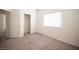 Bright bedroom featuring neutral carpet, a window with blinds, and a closet with sliding doors at 5391 Kennedy Hill Ave, Las Vegas, NV 89139