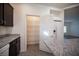 Modern kitchen features a pantry, stainless appliances, granite countertops, and dark wood cabinets at 5391 Kennedy Hill Ave, Las Vegas, NV 89139