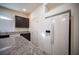 Bright kitchen featuring granite countertops, dark cabinets, a white refrigerator and stainless steel sink at 5391 Kennedy Hill Ave, Las Vegas, NV 89139