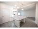 Spacious open kitchen with large island, white refrigerator, and modern pendant lights at 5391 Kennedy Hill Ave, Las Vegas, NV 89139