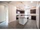 Kitchen with granite island, dark cabinets, and pendant lighting at 5391 Kennedy Hill Ave, Las Vegas, NV 89139