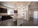 This open kitchen features granite countertops, an island, and stainless steel appliances at 5391 Kennedy Hill Ave, Las Vegas, NV 89139