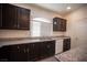 Kitchen features dark cabinetry, granite countertops, and stainless steel appliances at 5391 Kennedy Hill Ave, Las Vegas, NV 89139