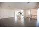 A broad living area combines living and dining with an open staircase, tile floors, and a view to the kitchen at 5391 Kennedy Hill Ave, Las Vegas, NV 89139