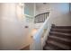 Carpeted staircase with white railing, decorative iron, and plenty of natural light at 5391 Kennedy Hill Ave, Las Vegas, NV 89139