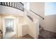 Elegant staircase with modern railing and natural light, creating a welcoming entry at 5391 Kennedy Hill Ave, Las Vegas, NV 89139