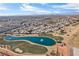 Aerial view showing home's proximity to a golf course and a lake at 5458 Walton Heath Ave, Las Vegas, NV 89142