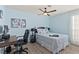 Serene bedroom with a ceiling fan, workspace, and neutral decor at 5608 Port Barrington Way, Las Vegas, NV 89130