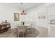 Sunlit dining room features a glass-top table, hardwood floors, and an open concept design at 5608 Port Barrington Way, Las Vegas, NV 89130