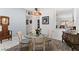 Bright dining room with glass table and four chairs, hardwood floors, and decorative accents at 5608 Port Barrington Way, Las Vegas, NV 89130