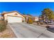 House exterior features a front yard, driveway, and two-car garage at 5608 Port Barrington Way, Las Vegas, NV 89130