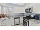 Well-equipped kitchen with stainless steel appliances and granite countertops at 5608 Port Barrington Way, Las Vegas, NV 89130