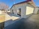 View of the property's backyard featuring fresh concrete and sliding glass doors at 619 Brush St, Las Vegas, NV 89107