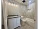 Bathroom features a new vanity, toilet, tub with tiled walls and decorative lighting at 619 Brush St, Las Vegas, NV 89107