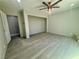 Bright bedroom features wood-look floors, neutral paint, ceiling fan, and open closet at 619 Brush St, Las Vegas, NV 89107