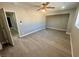 Bright bedroom features wood-look floors, ceiling fan, neutral walls and trim, and open closet at 619 Brush St, Las Vegas, NV 89107