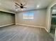 Bedroom features wood-look floors, window view, neutral paint, and access to bathroom at 619 Brush St, Las Vegas, NV 89107