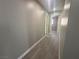 Hallway view featuring freshly painted walls and new laminate flooring at 619 Brush St, Las Vegas, NV 89107