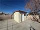 Exterior view of a backyard storage shed with door and window for organization and accessibility at 619 Brush St, Las Vegas, NV 89107