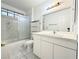 Bathroom with bathtub, shower, and white cabinets at 6402 Agua Dr, Las Vegas, NV 89103