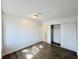 Bright bedroom with wood-look floors and sliding door closet at 6402 Agua Dr, Las Vegas, NV 89103