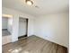 Spacious bedroom with wood-look floors and sliding door closet at 6402 Agua Dr, Las Vegas, NV 89103