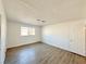 Large bedroom with wood-look floors and neutral walls at 6402 Agua Dr, Las Vegas, NV 89103