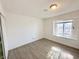 Well-lit bedroom with wood-look floors and a window at 6402 Agua Dr, Las Vegas, NV 89103