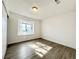 Bright bedroom with wood-look floors and large window at 6402 Agua Dr, Las Vegas, NV 89103