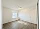 Sunny bedroom with wood-look floors and large window at 6402 Agua Dr, Las Vegas, NV 89103