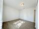 Bright bedroom with wood-look floors and door to bathroom at 6402 Agua Dr, Las Vegas, NV 89103