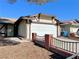 Front view of a house with an attached garage and brick fence at 6402 Agua Dr, Las Vegas, NV 89103