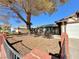 House exterior showcasing a front entrance and mature tree at 6402 Agua Dr, Las Vegas, NV 89103