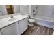 Bright bathroom features a bathtub and vanity with wood-look flooring at 7453 Vital Ct, Las Vegas, NV 89149