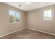 Bedroom with neutral carpet, walls and natural light from two windows at 7453 Vital Ct, Las Vegas, NV 89149