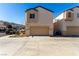 Attached garage with a tan exterior and driveway at 7453 Vital Ct, Las Vegas, NV 89149