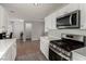 Modern kitchen with stainless steel appliances and white cabinetry at 7453 Vital Ct, Las Vegas, NV 89149