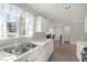 Kitchen with white cabinets, stainless steel appliances, and a double sink at 7453 Vital Ct, Las Vegas, NV 89149