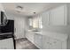 White kitchen with stainless steel appliances and a view into the dining area at 7453 Vital Ct, Las Vegas, NV 89149