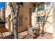 Small patio with table and chairs, surrounded by trees at 7453 Vital Ct, Las Vegas, NV 89149