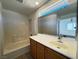 Bathroom with tub, wood vanity and large mirror at 938 Cantabria Heights Ave, Las Vegas, NV 89183