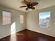 Well-lit bedroom with hardwood floors and two windows at 938 Cantabria Heights Ave, Las Vegas, NV 89183