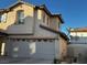 Two-story house with attached garage, satellite dish, and neutral color scheme at 938 Cantabria Heights Ave, Las Vegas, NV 89183