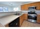 Spacious kitchen with stainless steel appliances and wood cabinets at 938 Cantabria Heights Ave, Las Vegas, NV 89183